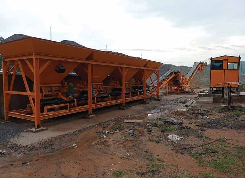 Rockmix RWMM wet mix macadam plant with four-bin feeder, conveyors and control cabin on site